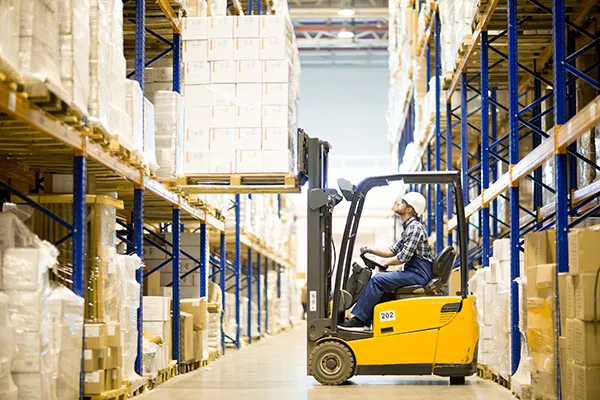 Warehouse driver operating forklift