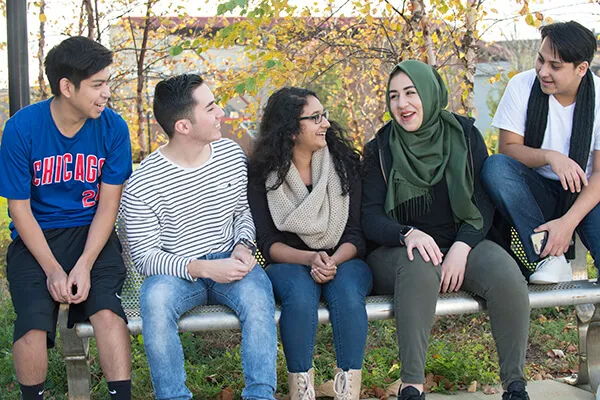 International students sitting together on a bench