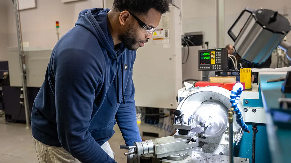 Student using a CNC machine