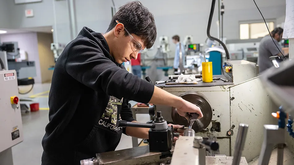 Student using a CNC machine
