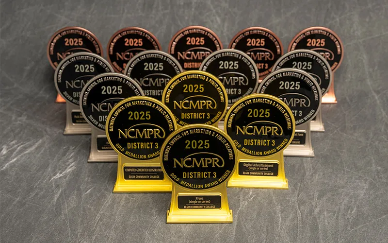 15 National Council of Marketing and Public Relations Medallion Awards with a gray backdrop in the back.