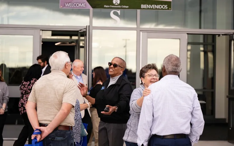 Dr. Cathy Taylor and others smile outside the new MTC.