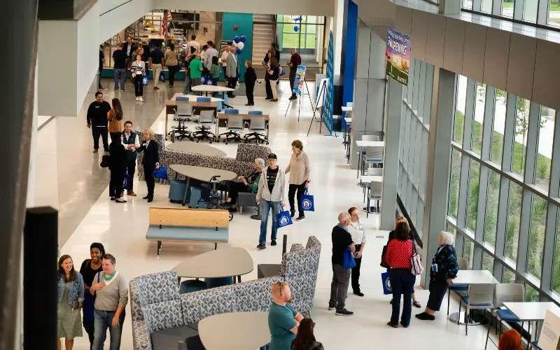 Many people walking inside the new Manufacturing & Technology Center at ECC.