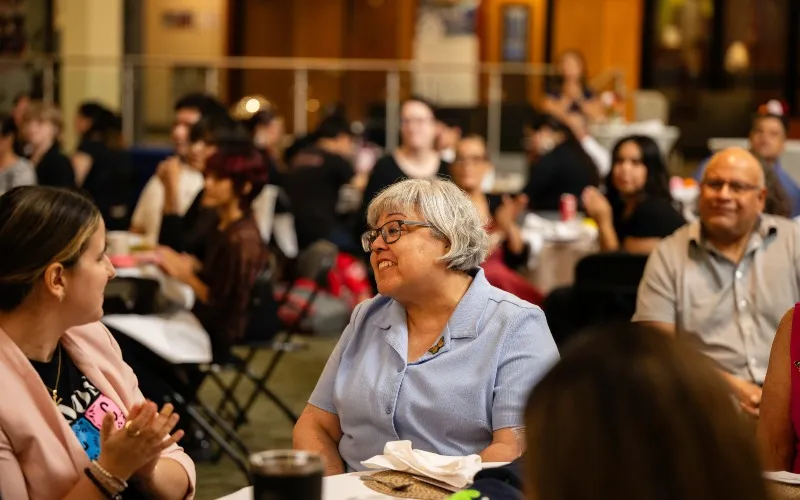 Elena Gardea, ECC's Adult Education Transitions Coordinator, smiles in the audience at the Jane Barbosa Legacy Brunch in September 2026. Gardea received the  We Rise Staff Member Award.