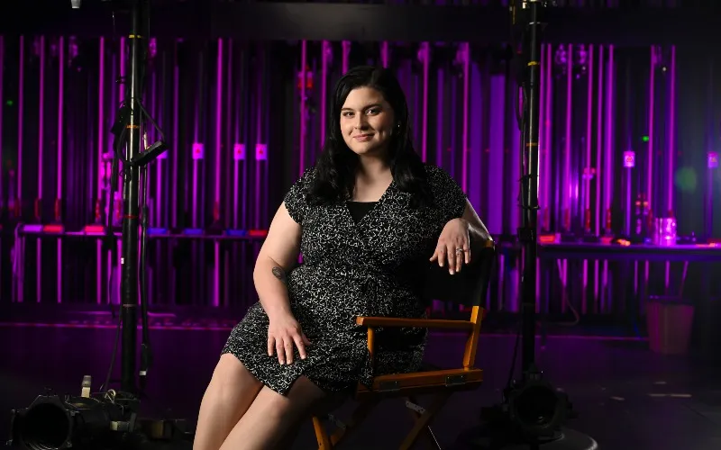 Alumna Katrina Syrris poses backstage at the ECC'S Blizzard Theatre.