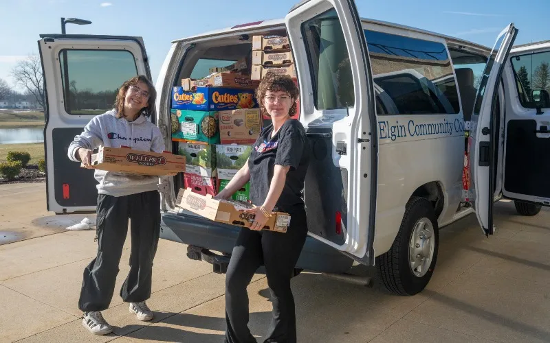 Sid Perkins and Laci VerCande unload food for Spartan Pantry.