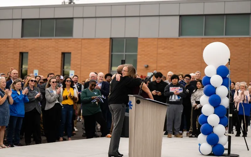 Dr. Cathy Taylor and President Peggy Heinrich embrace at the new MTC grand opening event.