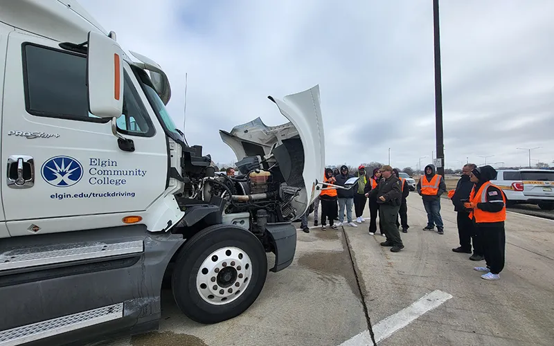 ECC truck driving program students and faculty view a live commercial vehicle inspection at the I-55 southbound weight station in Bolingbrook, Ill.