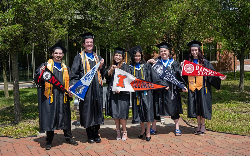 Group photo of ECC graduates holding transfer university flags.
