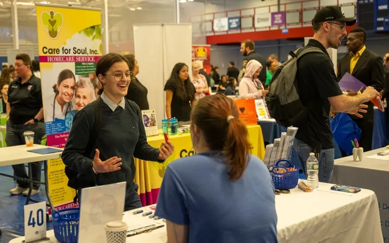Two people talk at a past job fair at ECC.