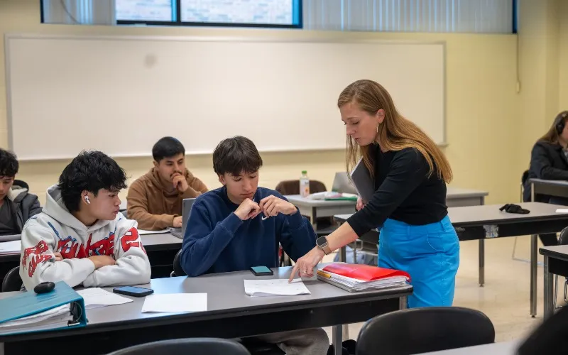 Professor helps a student during math class.