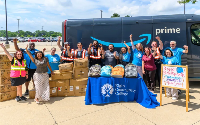 A group of ECC employees and community members pose at the Project Backpack event in 2025.
