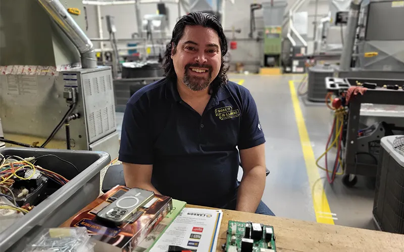 Professor George Rosa poses in an HVAC lab in Building O.