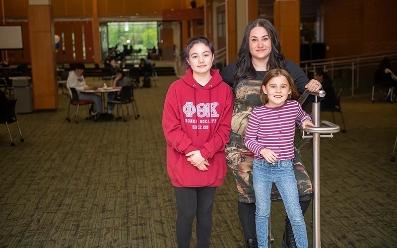 Elgin Community College Spring 2024 Graduate Arielle Gonzalez-Guerra with her daughters, Ava and Lydia