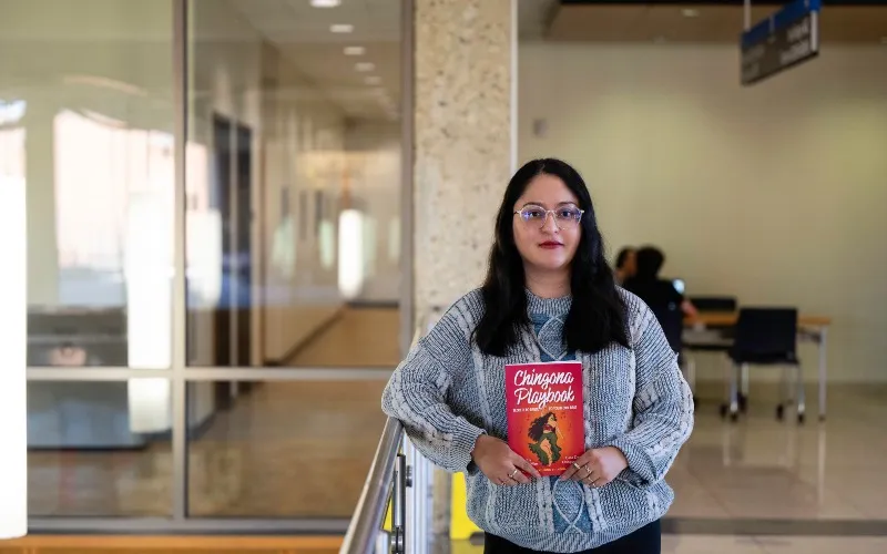 Vanessa Macias Arias poses with her book 