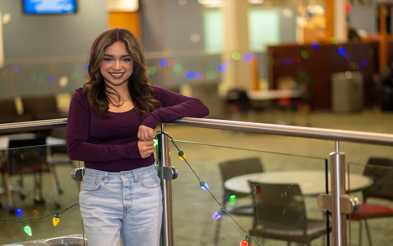 La exalumna Maritza García posa junto al salón Jobe de ECC.