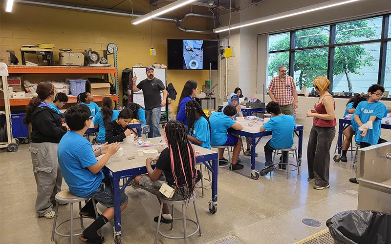ECC visual art professors teach members of the Elgin Boys & Girls Club of North Central Illinois about pottery during a visit.
