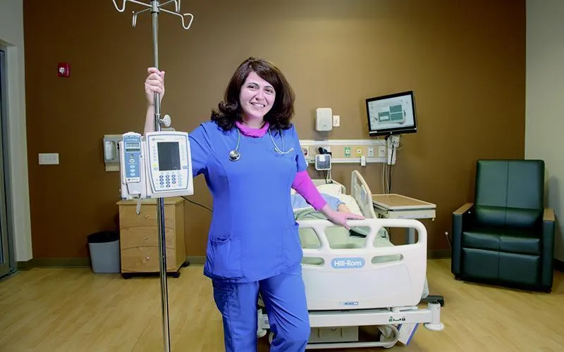 ECC alumna Cathleen Nesheiwat cares for COVID-19 patients.