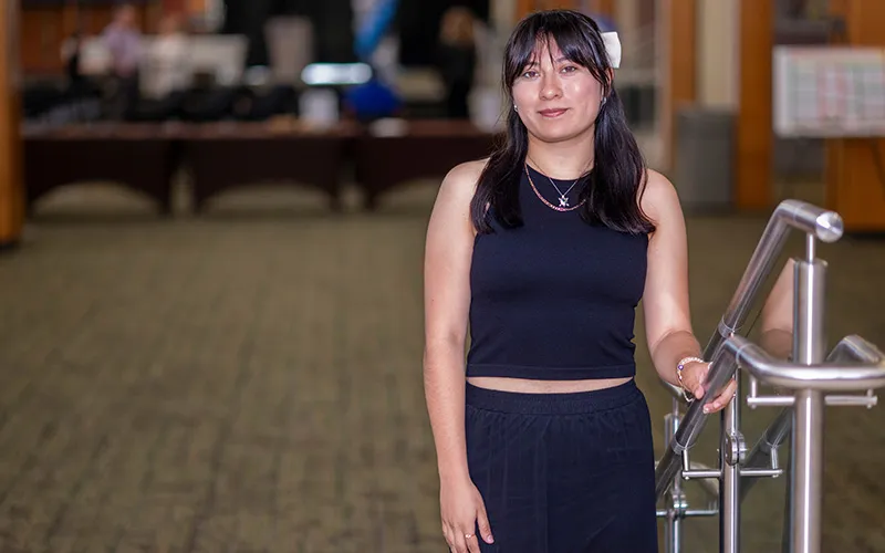 A student stands in the Jobe Lounge