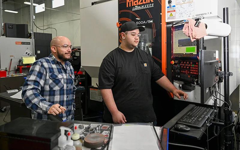 Instructor with a student using a computer