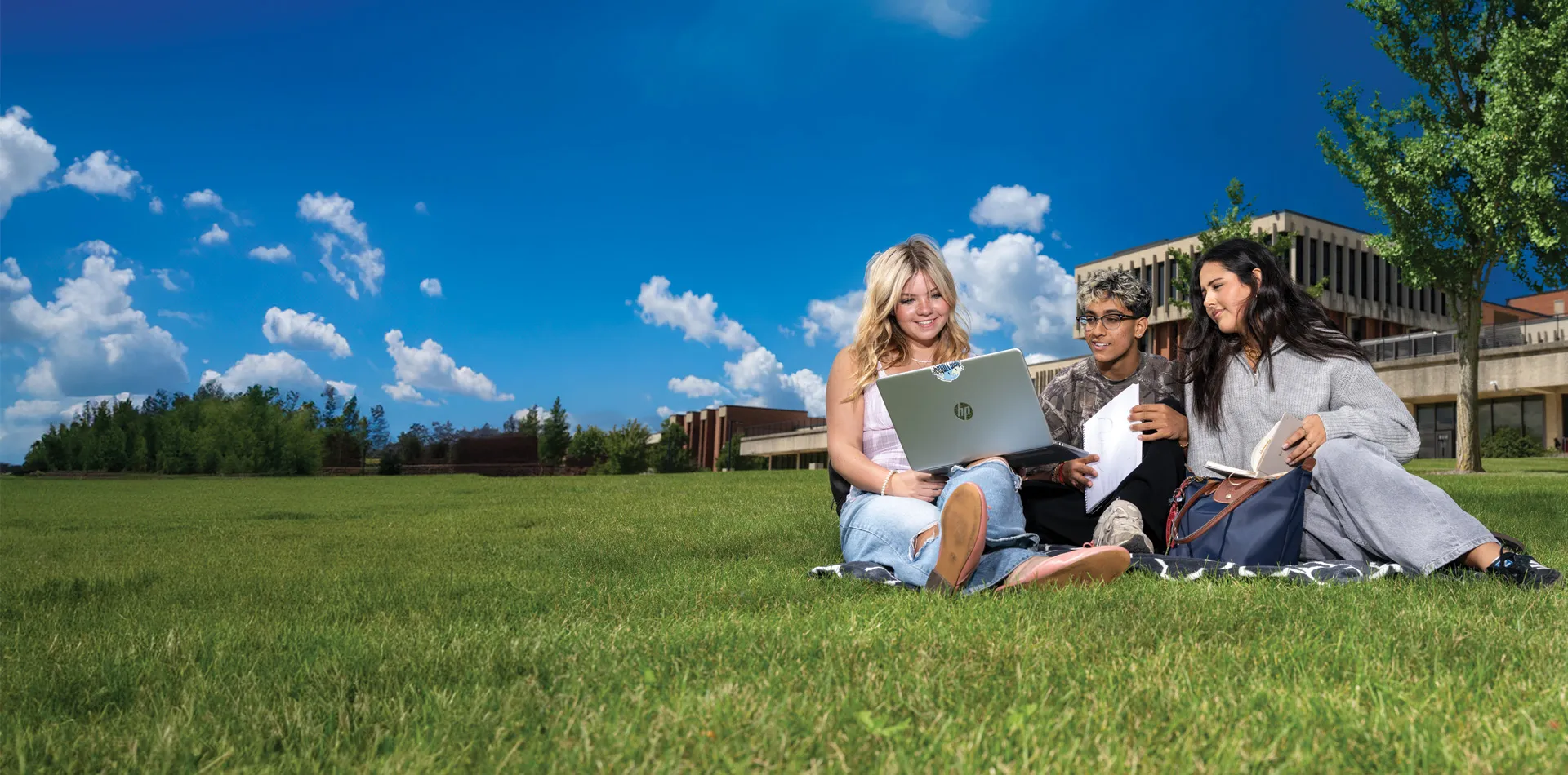 Students sitting on a grass conversing
