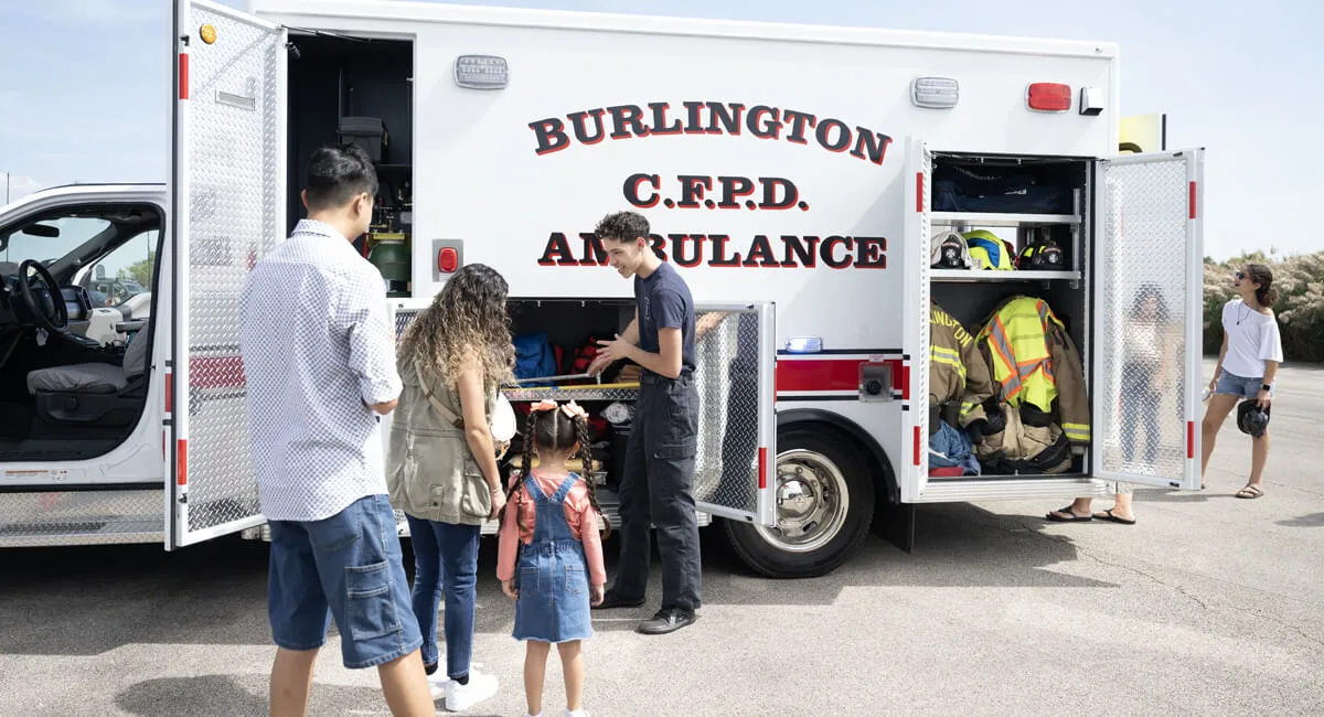 Paramedic showing features of an ambulance at a touch a truck event.