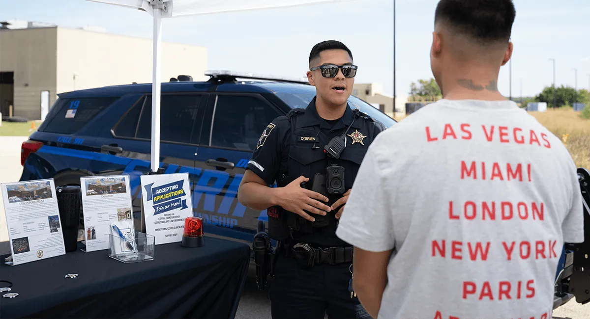 A police officer talking with a guest at an open house event