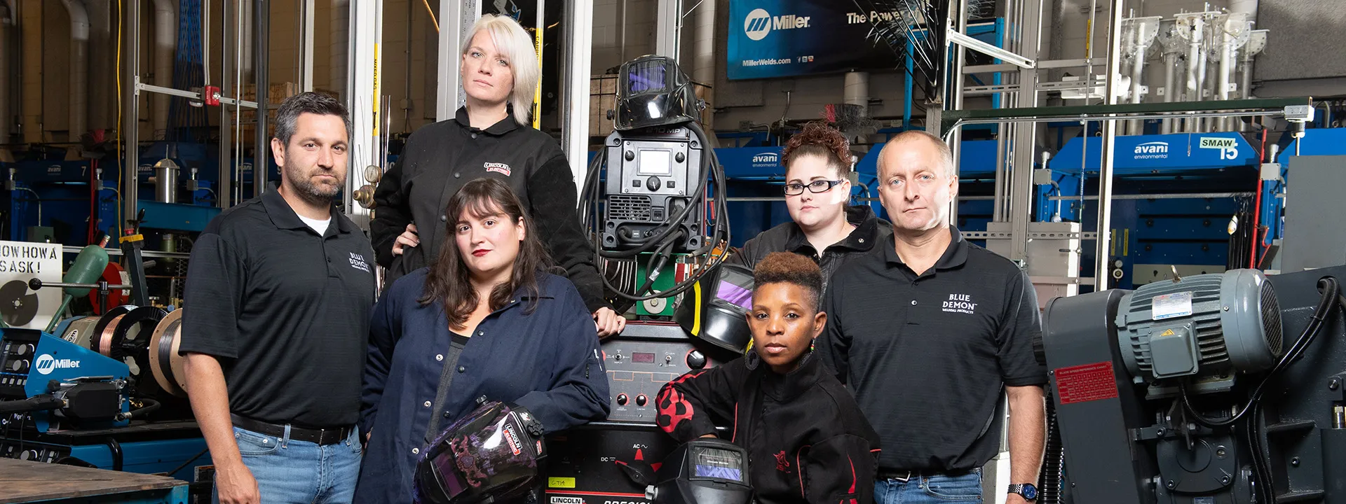 Manufacturing and technology employees sitting together and smiling