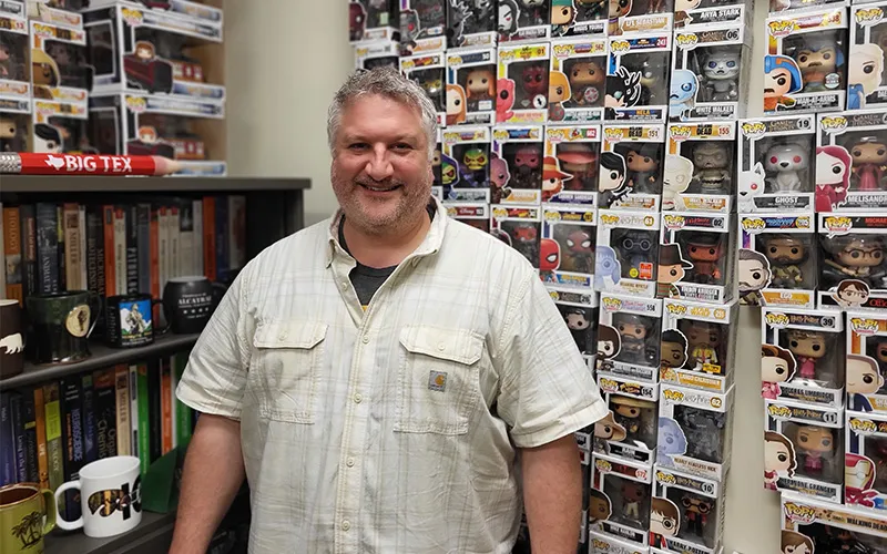 Dana Kurpius stands in his office