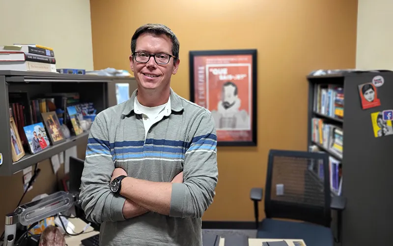 Joshua Thusat stands in his office
