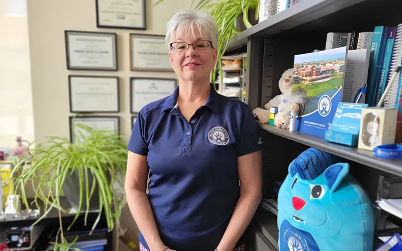 Kim Plate stands in her office