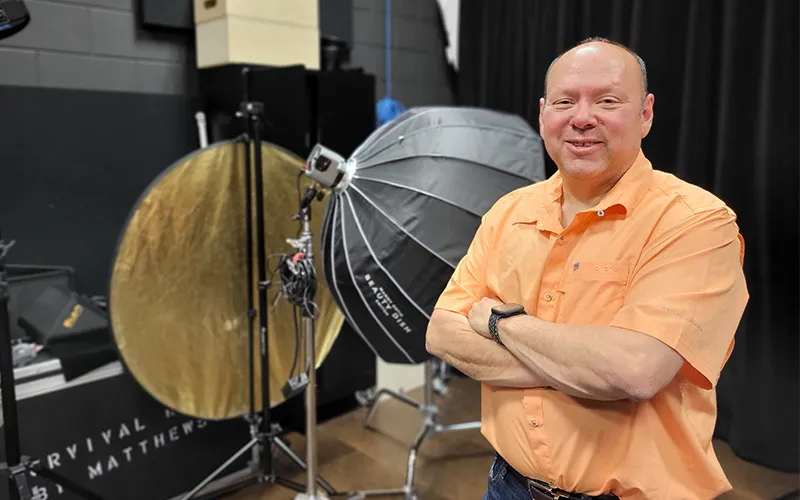 Mark Carriveau stands in the photography studio