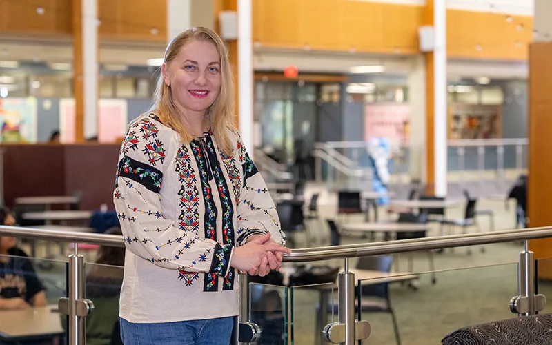 A student stands in the Jobe Lounge