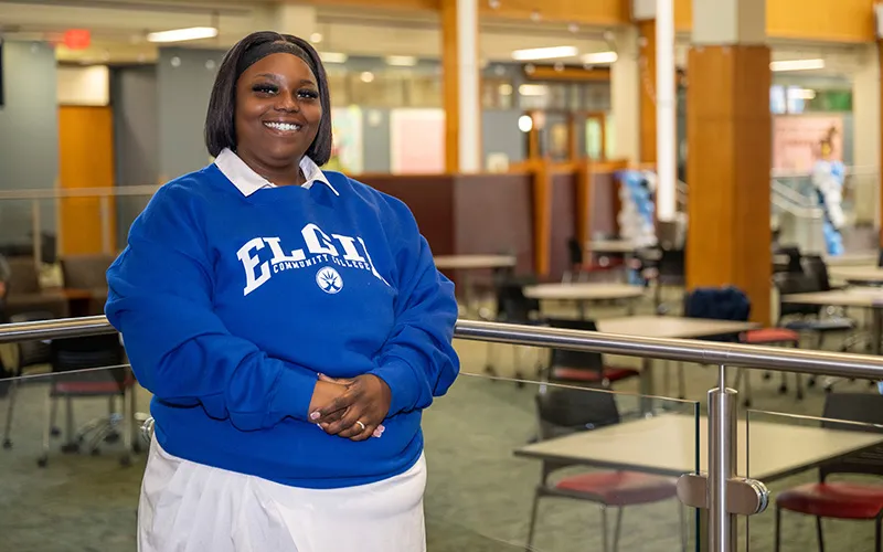 A student stands in the Jobe Lounge
