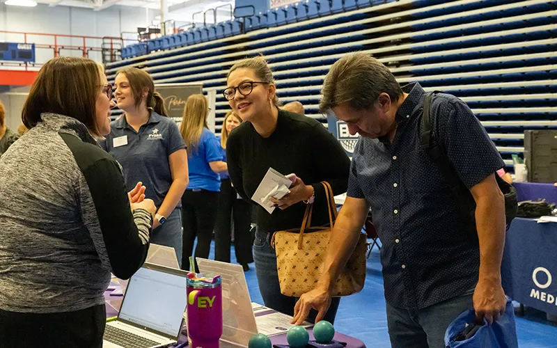 Two people talking at a job fair