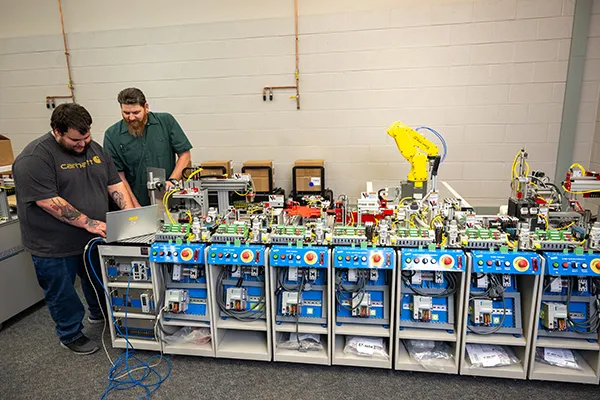 Instructor helps a student in the IMT department