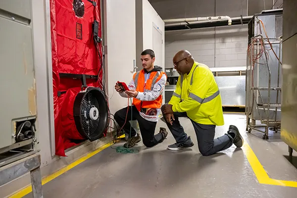 ECC instructor guides a student in the HVAC department