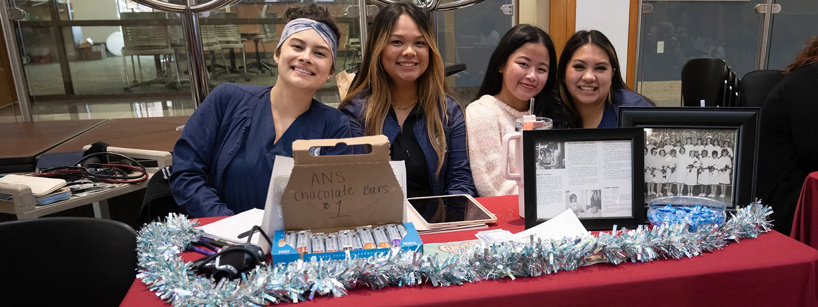 Associated Nursing Students sitting at club table