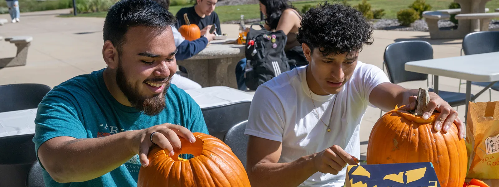 students carving pumpkins