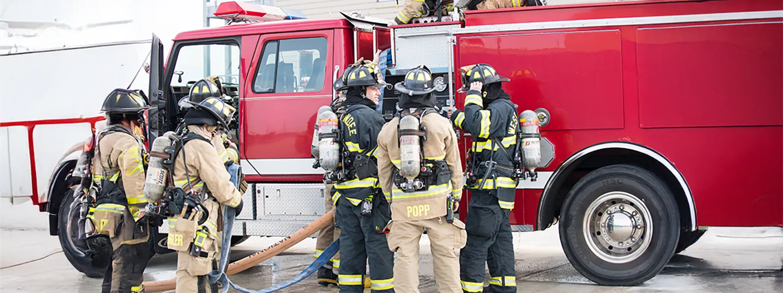 Firefighters standing near fire truck