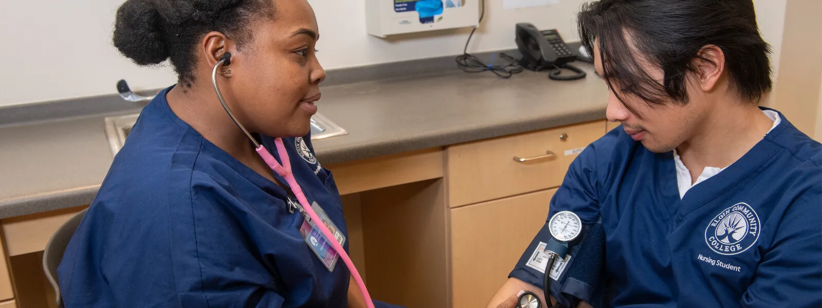 Students practice take blood pressure on each other