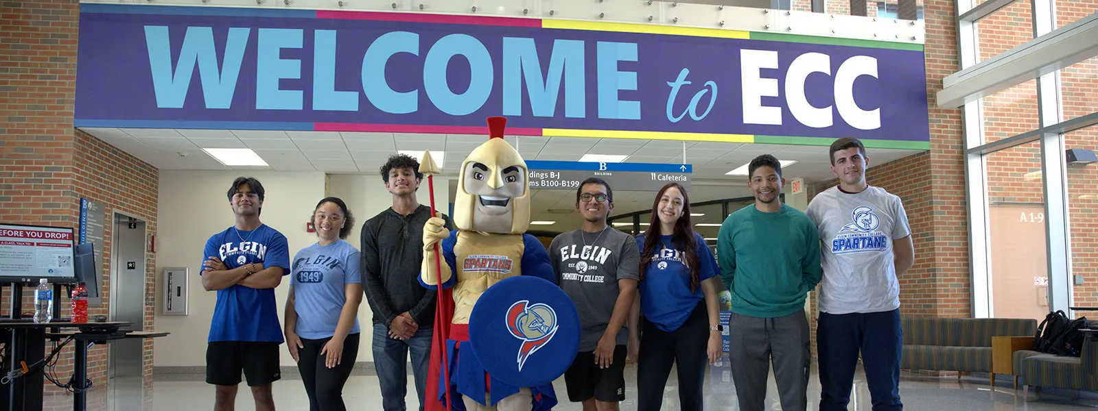 Students with Spartacus in building A hallway