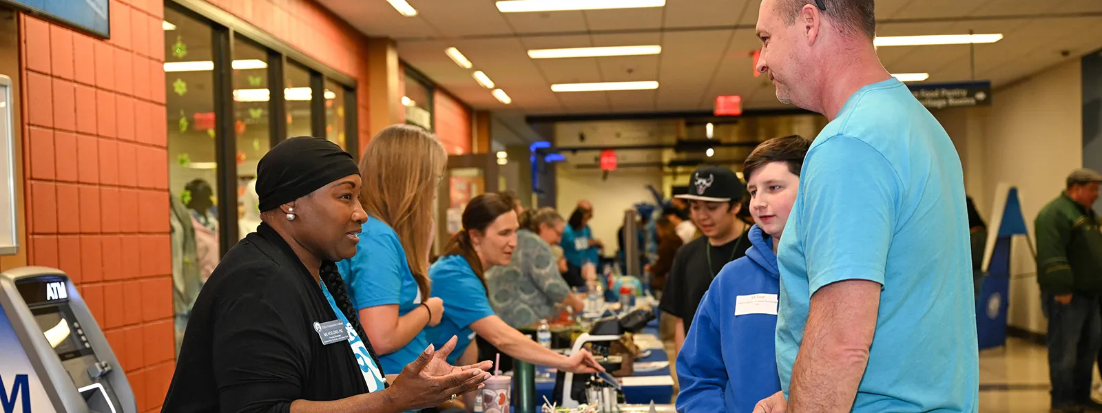 An ECC employee talking to a parent and potential student