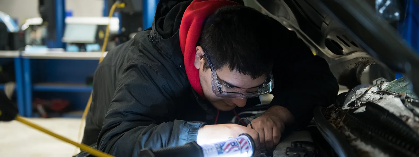 Automotive student working on a car