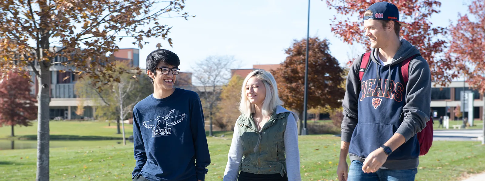 3 ECC students talking and walking together on campus