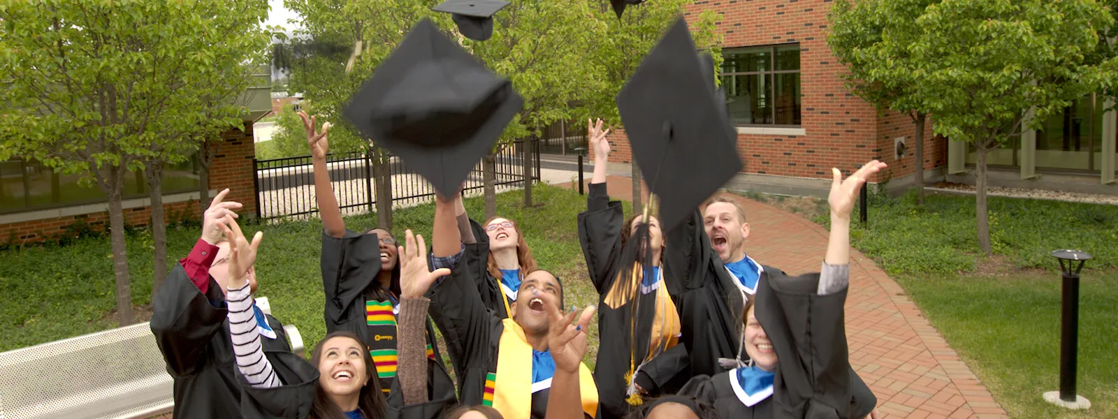 Graduation Caps being thrown in the air by students in celebration of graduation.