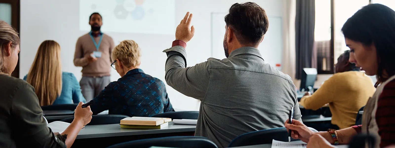 Student in class raising hand