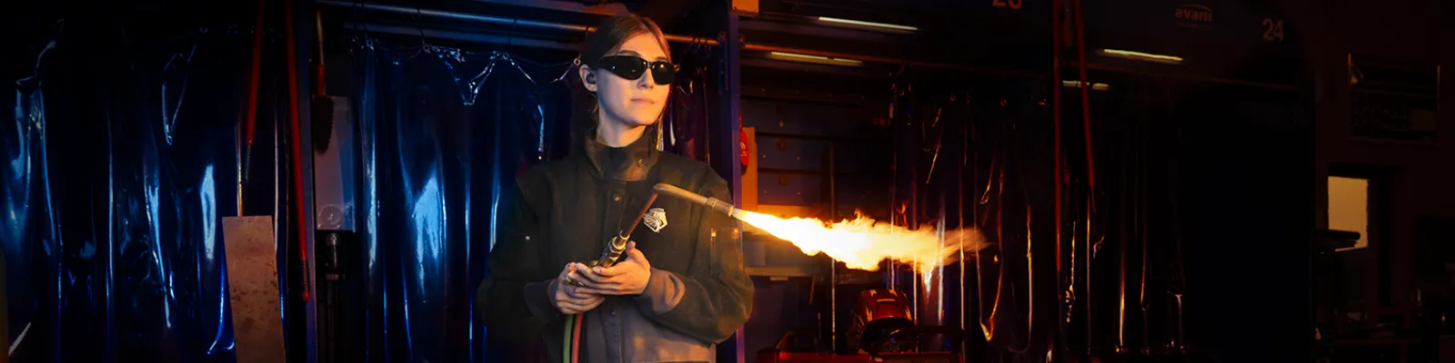 Welding student holding a welding torch.