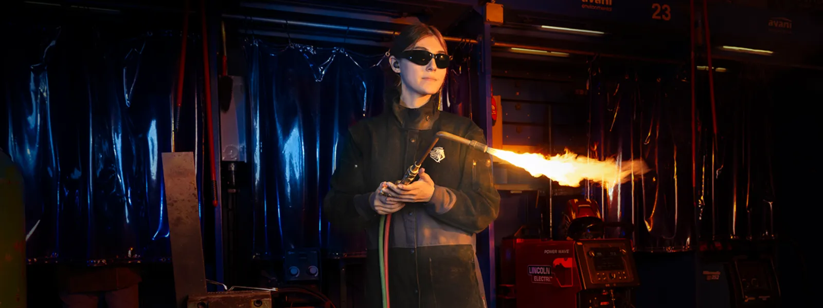 Welding student holding a welding torch.