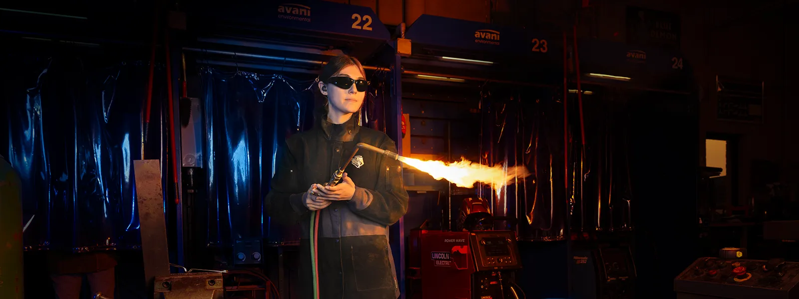 Welding student holding a welding torch.